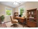 Office boasts natural lighting through windows, hardwood desk and chair at 4154 W Briarwood Lake S Dr, Monrovia, IN 46157