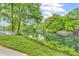 Scenic water view featuring lush green trees reflecting beautifully along the shore at 4154 W Briarwood Lake S Dr, Monrovia, IN 46157