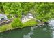 Picturesque lake view of waterfront homes with docks surrounded by mature trees at 4154 W Briarwood Lake S Dr, Monrovia, IN 46157