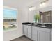 Modern bathroom with a double vanity, sleek countertops, and a window offering natural light and serene views at 4159 Persian St, Greenwood, IN 46143
