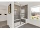 Contemporary bathroom featuring a glass enclosed shower with a built-in bench, complemented by a bright window view at 4159 Persian St, Greenwood, IN 46143