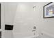 Bright bathroom with a shower and tub combination with white tile, curtain and whimsical dog art at 4159 Persian St, Greenwood, IN 46143
