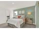 Bedroom showcases soft green walls, a plush bed, and decorative nightstands illuminated by warm lamps at 4159 Persian St, Greenwood, IN 46143