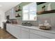 Well-lit kitchen featuring gray cabinets, subway tile backsplash, and open shelving at 4159 Persian St, Greenwood, IN 46143