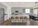 Modern kitchen with island featuring seating, gray cabinets, stainless appliances, and dining area at 4159 Persian St, Greenwood, IN 46143
