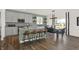 Bright kitchen with island, seating, gray cabinets, stainless appliances, and an adjacent dining area at 4159 Persian St, Greenwood, IN 46143