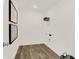 A clean laundry room has stylish vinyl flooring, minimalist artwork, and practical shelving for storage at 4159 Persian St, Greenwood, IN 46143