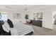 Cozy bedroom featuring a tufted headboard, modern light fixture, with views to other rooms in the home at 4159 Persian St, Greenwood, IN 46143