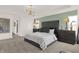 Elegant main bedroom with a tufted headboard, modern light fixture, and calming color scheme for a serene retreat at 4159 Persian St, Greenwood, IN 46143