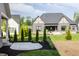 Well-maintained backyard with manicured grass and view of Tudor-style home at 4190 Hartswick Ct, Zionsville, IN 46077