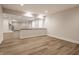 Unfurnished basement featuring hardwood flooring, recessed lighting, and a bar at 4190 Hartswick Ct, Zionsville, IN 46077