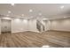 Spacious finished basement with hardwood floors, recessed lighting, and stairs at 4190 Hartswick Ct, Zionsville, IN 46077