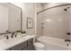 Bathroom with a tub and shower, and a gray vanity with marble countertops at 4190 Hartswick Ct, Zionsville, IN 46077