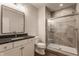 Modern bathroom featuring a glass enclosed shower, undermount sink, and stone tile at 4190 Hartswick Ct, Zionsville, IN 46077