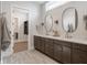 Elegant bathroom featuring double vanity, stylish mirrors, and an open closet at 4190 Hartswick Ct, Zionsville, IN 46077