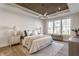 Bright bedroom features a wood tray ceiling, large windows, and stylish decor at 4190 Hartswick Ct, Zionsville, IN 46077