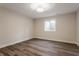 Bright bedroom featuring hardwood floors, white trim, and a window at 4190 Hartswick Ct, Zionsville, IN 46077