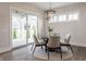 Cozy dining area features contemporary chandelier, table with seating for six, and view of the patio at 4190 Hartswick Ct, Zionsville, IN 46077