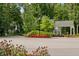 Community entry gate with colorful flowers and a guard house at 4190 Hartswick Ct, Zionsville, IN 46077