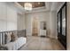 Elegant foyer featuring paneled walls, a tray ceiling, and stylish furniture, complemented by hardwood floors at 4190 Hartswick Ct, Zionsville, IN 46077