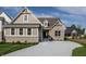 Charming home with a brick and siding exterior, complemented by a well-manicured lawn and a concrete driveway at 4190 Hartswick Ct, Zionsville, IN 46077