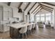 Open-concept kitchen with a large island, modern pendant lights, and seamless flow into the living room at 4190 Hartswick Ct, Zionsville, IN 46077