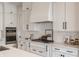 Bright kitchen with white cabinets, stainless steel appliances, subway tile backsplash and modern fixtures at 4190 Hartswick Ct, Zionsville, IN 46077