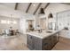 Open-concept kitchen with an island bar, stainless steel appliances, and a view of the dining area at 4190 Hartswick Ct, Zionsville, IN 46077