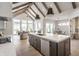 Stunning kitchen featuring a large island, modern appliances, and vaulted ceilings with exposed beams at 4190 Hartswick Ct, Zionsville, IN 46077