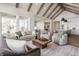 Spacious living room with exposed beams, comfortable seating, and an open layout to the kitchen at 4190 Hartswick Ct, Zionsville, IN 46077