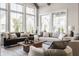 Bright living room features large windows, comfortable seating, and a stylish coffee table at 4190 Hartswick Ct, Zionsville, IN 46077