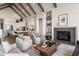 Stylish living room with fireplace, comfortable seating, and an open layout to the kitchen at 4190 Hartswick Ct, Zionsville, IN 46077