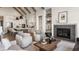 Open-concept living room showcasing a fireplace, stylish furniture, and view of the modern kitchen at 4190 Hartswick Ct, Zionsville, IN 46077