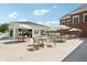 Inviting outdoor patio with tables, chairs, and umbrellas near a clubhouse at 4190 Hartswick Ct, Zionsville, IN 46077