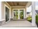 Covered patio featuring concrete flooring, brick accents, wood ceiling, and sliding glass doors at 4190 Hartswick Ct, Zionsville, IN 46077