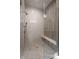 Walk-in shower featuring tiled walls, glass door, and built-in bench at 4190 Hartswick Ct, Zionsville, IN 46077