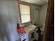 Modest bathroom featuring a single vanity, standard toilet, and a large mirror for functionality at 421 N Canal St, Alexandria, IN 46001