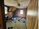 Cozy bedroom featuring wood paneled walls, carpeted floors, and a ceiling fan for added comfort at 421 N Canal St, Alexandria, IN 46001