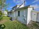 View of home exterior with white siding, green grass, and blue skies at 421 N Canal St, Alexandria, IN 46001