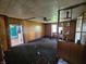 Inviting living room with wood paneled walls, carpeted floors, and a ceiling fan for added comfort at 421 N Canal St, Alexandria, IN 46001