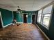 Spacious living room with hardwood floors, and green paneled walls at 421 N Canal St, Alexandria, IN 46001