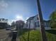 A charming white home with a street view and a patch of green grass at 421 N Canal St, Alexandria, IN 46001