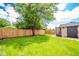 A fenced in backyard with lush green grass and a shed at 433 N 15Th Ave, Beech Grove, IN 46107