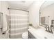 Bathroom with granite countertop and striped shower curtain at 433 N 15Th Ave, Beech Grove, IN 46107