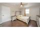 Cozy bedroom with wood floor, ceiling fan, and light yellow comforter at 433 N 15Th Ave, Beech Grove, IN 46107