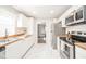 Bright kitchen with white cabinets, stainless steel appliances, and butcher block countertops at 433 N 15Th Ave, Beech Grove, IN 46107