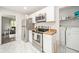 Bright kitchen with stainless steel appliances and hardwood countertops plus view to adjacent laundry area at 433 N 15Th Ave, Beech Grove, IN 46107