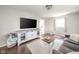 Open living room with lots of natural light, wood floors, TV, and a sofa at 433 N 15Th Ave, Beech Grove, IN 46107
