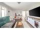 Relaxing living room with plush sofa, area rug, hardwood floors and entertainment center at 433 N 15Th Ave, Beech Grove, IN 46107
