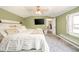 Comfortable bedroom features a ceiling fan, a window, and an attached bathroom entrance at 433 N 15Th Ave, Beech Grove, IN 46107